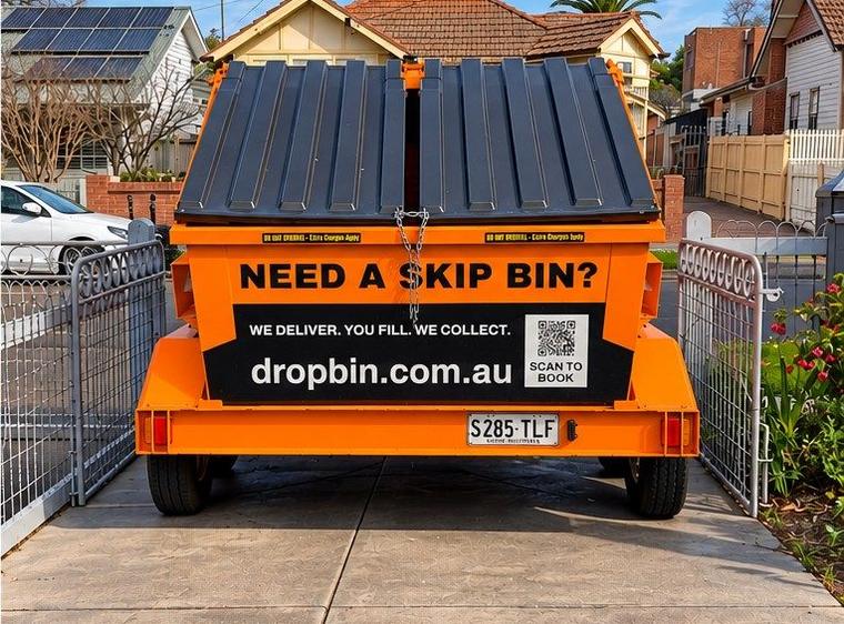 DropBin trailer on a concrete driveway between two front gates