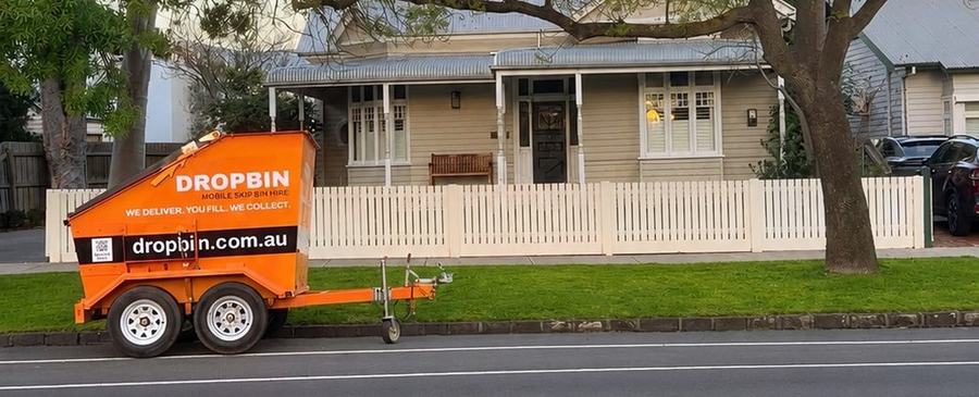 DropBin trailer parked at the kerb on a residential street in front of a house